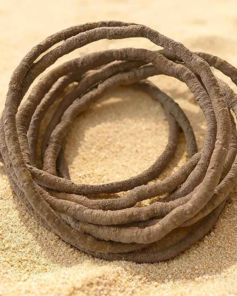 Jungle vine coiled on sand, close view of the texture